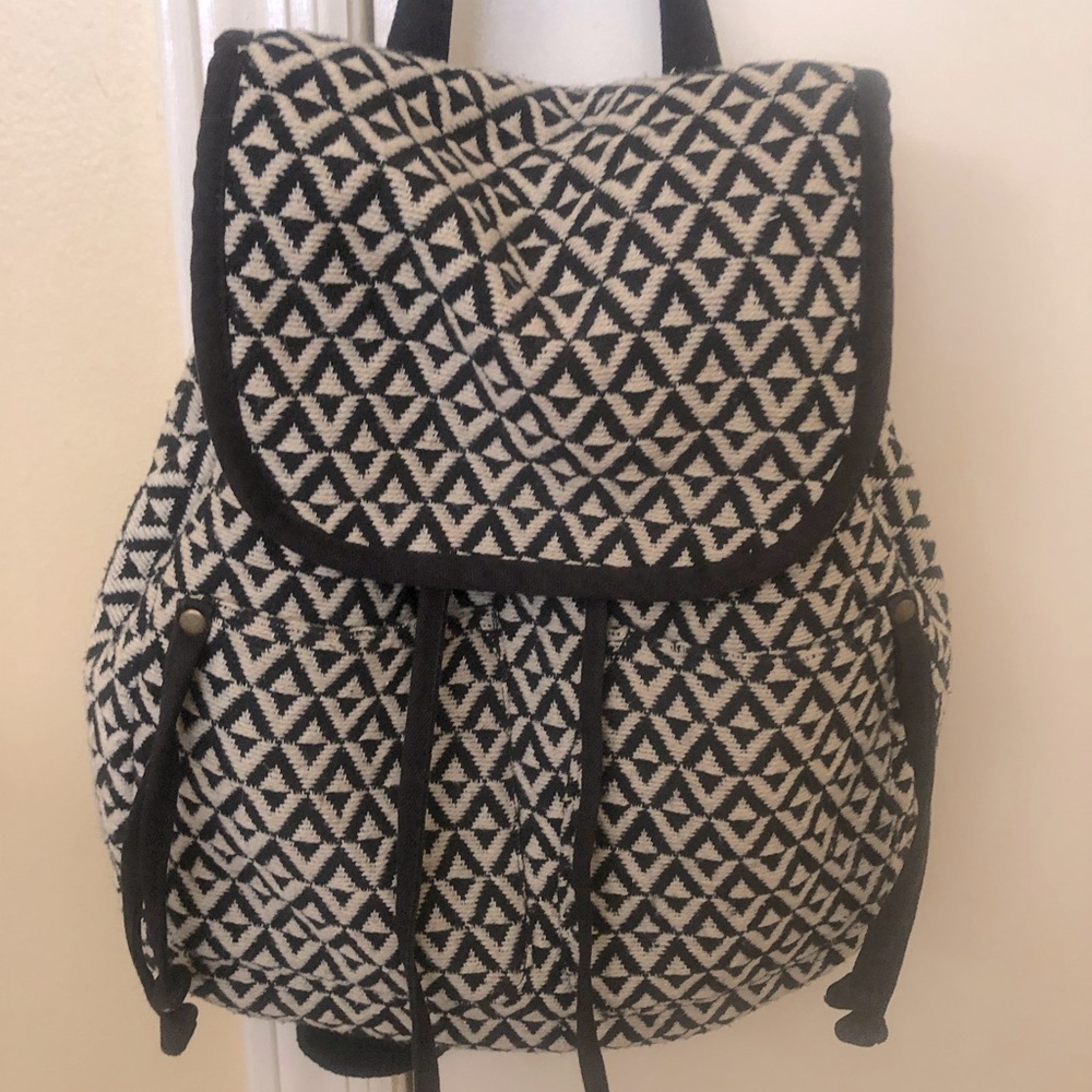 Medium sized cream and black cloth backpack.
